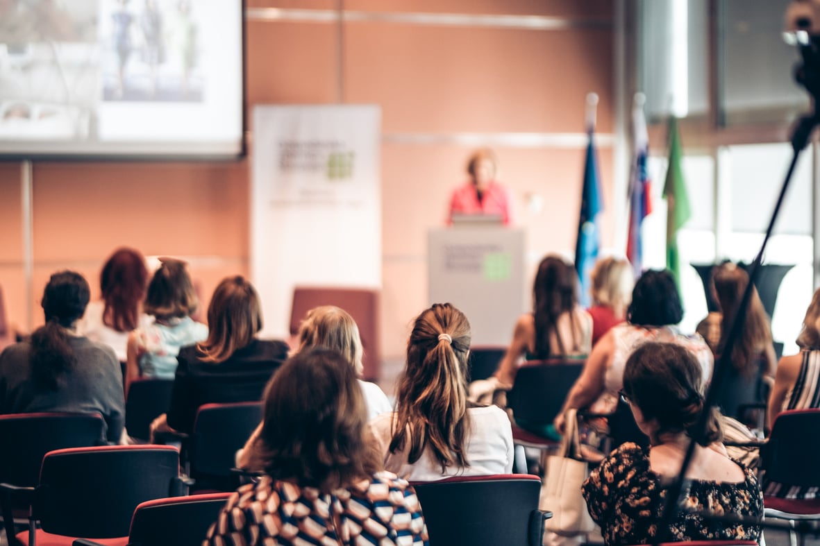 Woman Giving Presentation on Business Conference Event.